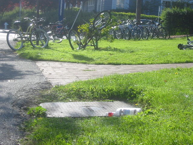 A very artsy picture of campus early in the morning.  Note the bottle of smirnoff in the foreground combined with the bike chaos